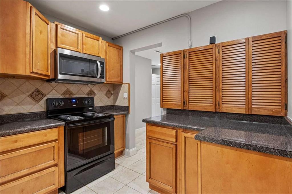 2115 Julien Overlook, Unit 2 Conyers, GA 30012 - Photo 12 of 13 a kitchen with stainless steel appliances granite countertop a stove a sink and a microwave
