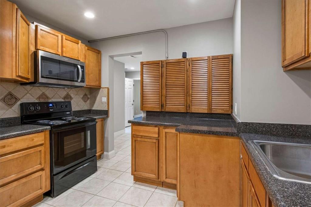 2115 Julien Overlook, Unit 2 Conyers, GA 30012 - Photo 13 of 13 a kitchen with stainless steel appliances granite countertop a stove a sink and a microwave