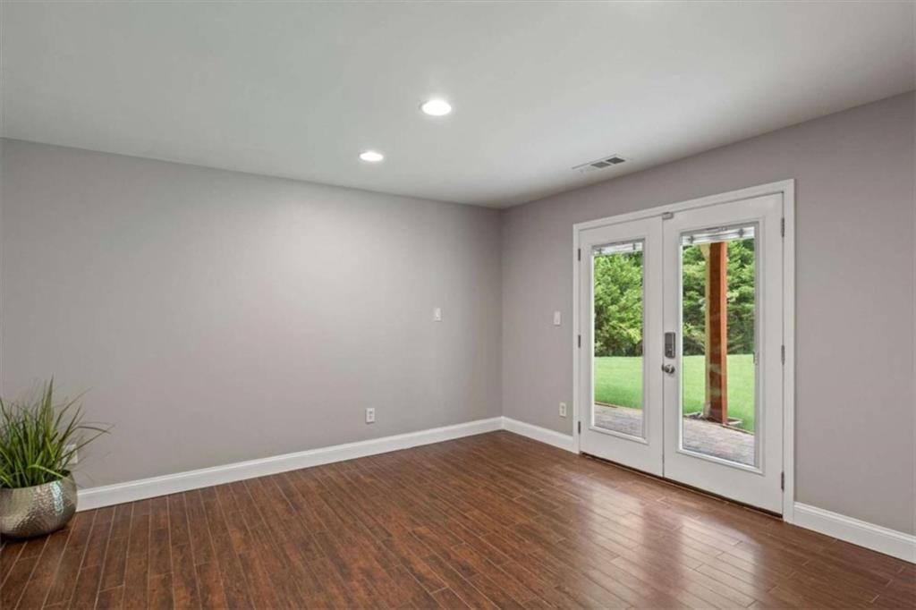 2115 Julien Overlook, Unit 2 Conyers, GA 30012 - Photo 7 of 13 a view of an empty room with wooden floor and a window