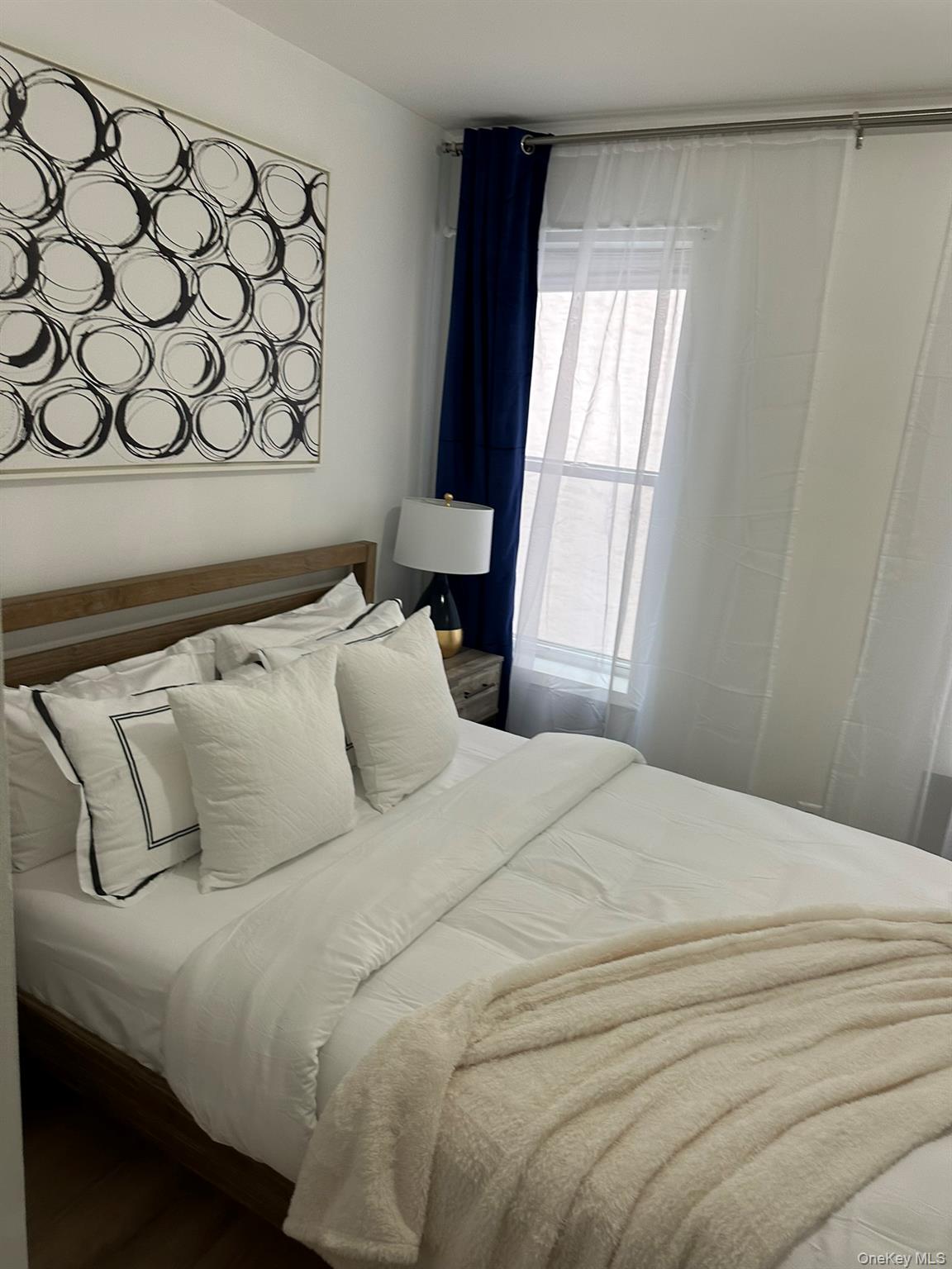 1435 2nd Avenue Manhattan, NY 10021 - Photo 28 of 33 a bedroom with a bed and a window