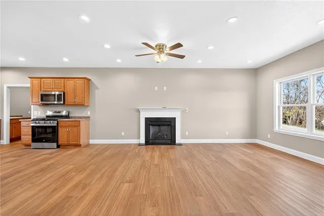 an empty room with windows and a fireplace