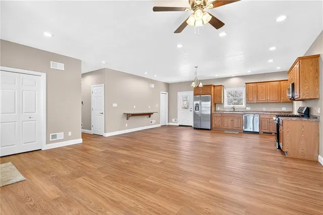 a kitchen with stainless steel appliances a refrigerator and a stove top oven