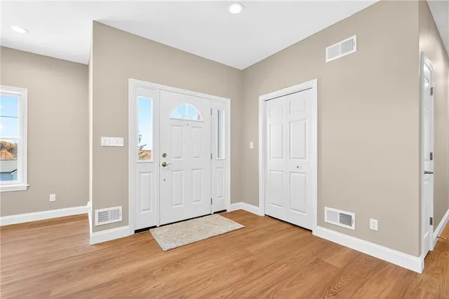 a view of an empty room with window and cabinet