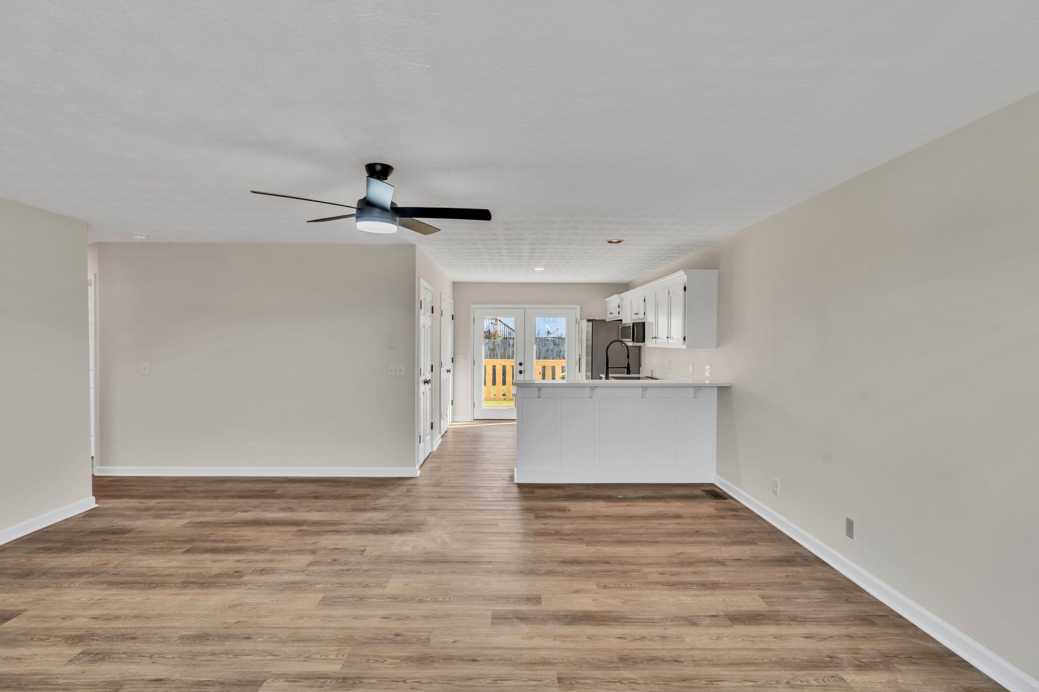 2338 South Main Street Springfield, TN 37172 - Photo 7 of 30 a view of a kitchen with wooden floor and a ceiling fan