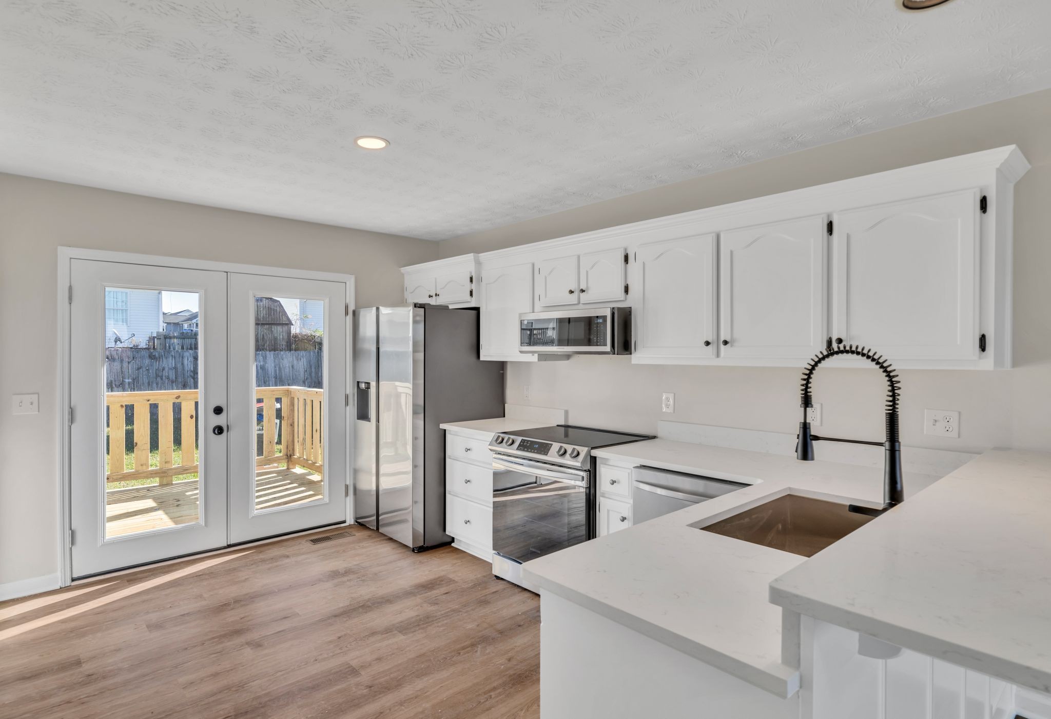 2338 South Main Street Springfield, TN 37172 - Photo 8 of 30 a kitchen with white cabinets and stainless steel appliances