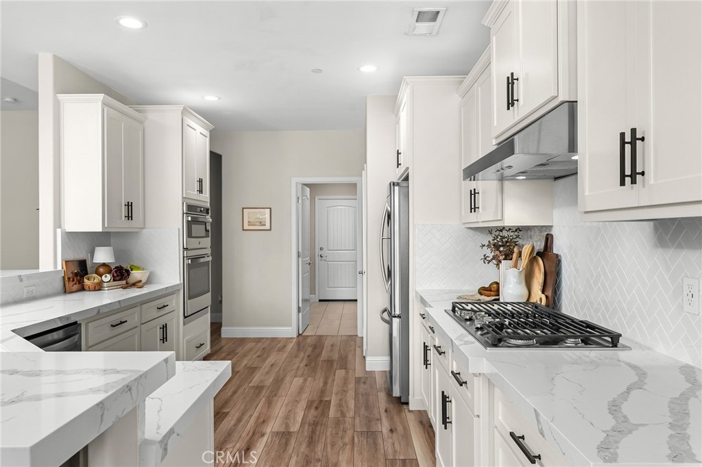 1971 Potter Road Chico, CA 95928 - Photo 3 of 59 a kitchen with stainless steel appliances a stove a sink dishwasher and cabinets with wooden floor