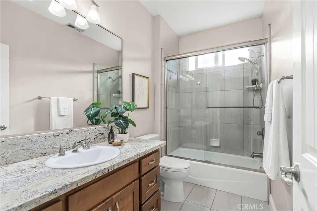 1971 Potter Road Chico, CA 95928 - Photo 31 of 59 a bathroom with a granite countertop sink a toilet and shower