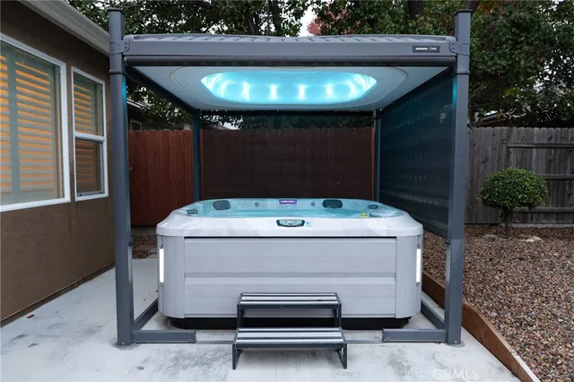 a view of washer and dryer with wooden fence