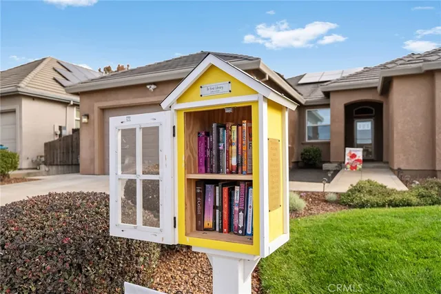 a front view of a house with a garden and plants