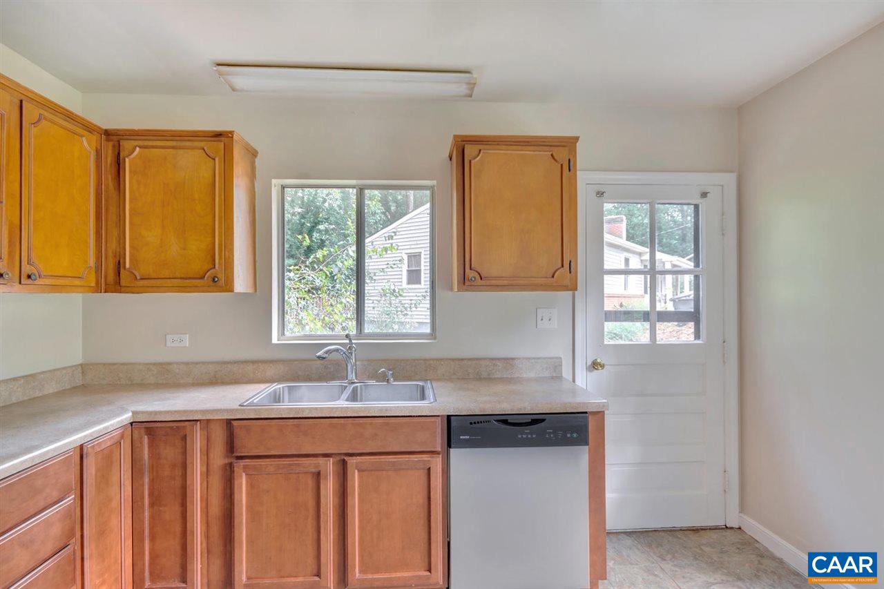 1522 Trailridge Road Charlottesville, VA 22903 - Photo 10 of 22 a kitchen with granite countertop a sink a window and cabinets