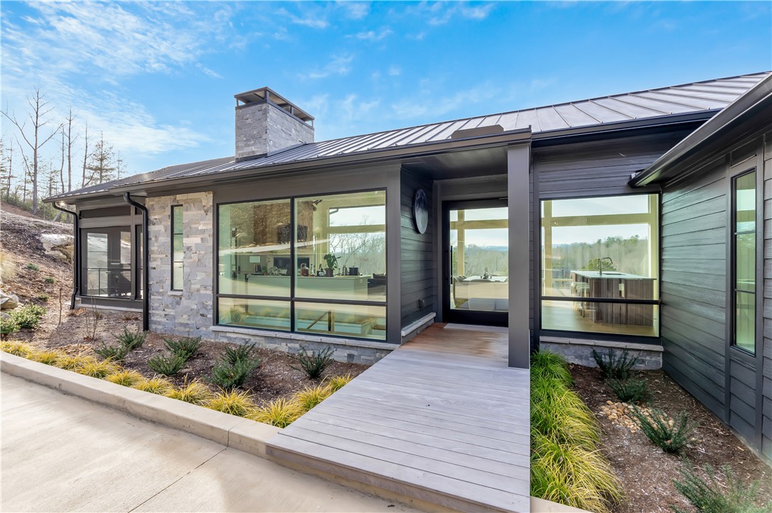 127 Crosswind Court Sunset, SC 29685 - Photo 8 of 49 This modern home features expansive windows that invite the outdoors in, offering serene views.