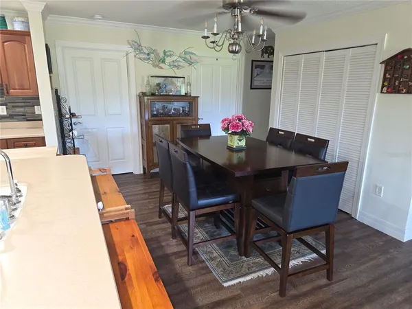 a view of a dining room with furniture and chandelier