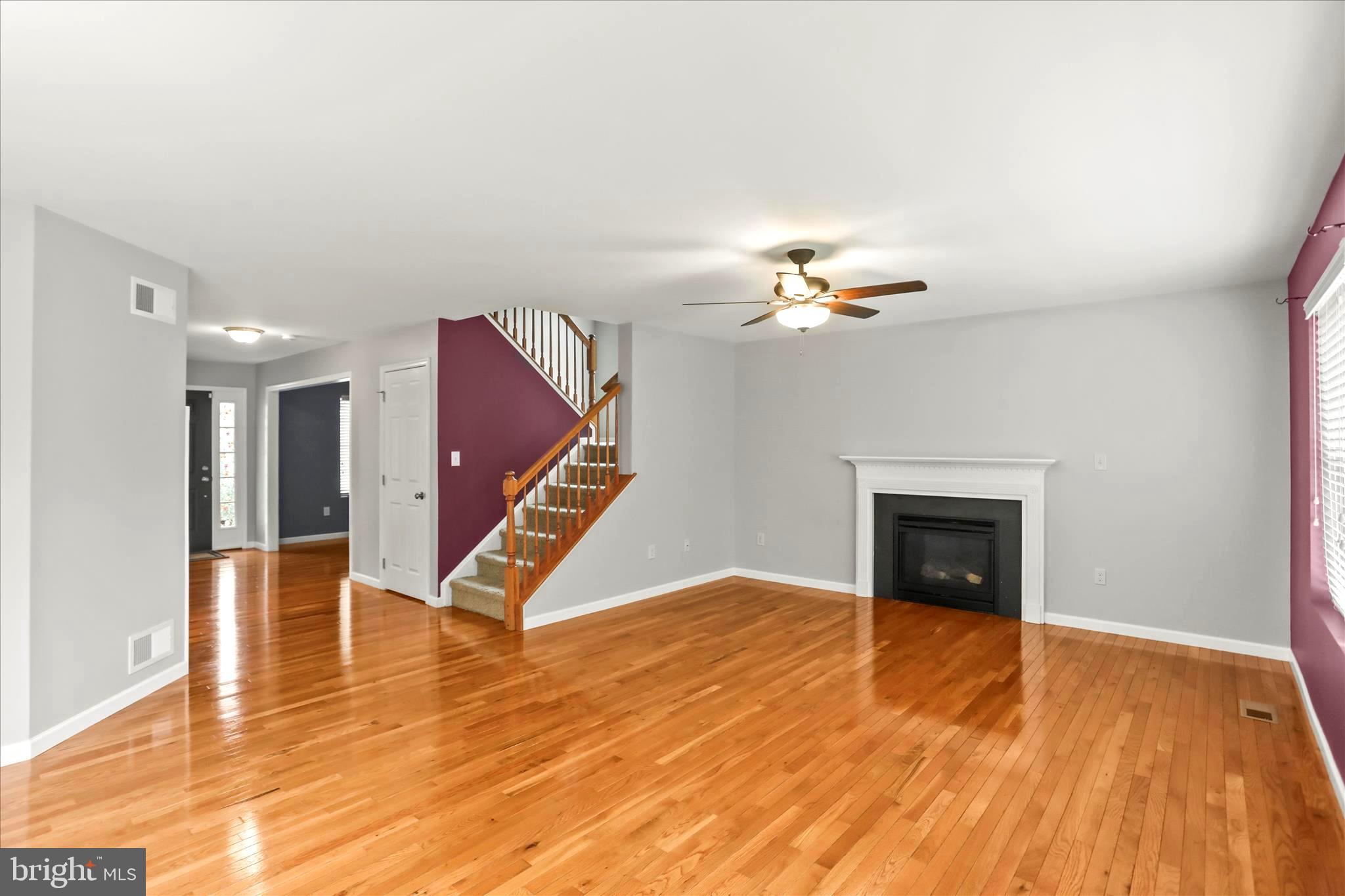 26 South 3rd Street New Freedom, PA 17349 - Photo 21 of 64 a view of an empty room with wooden floor fireplace and a window