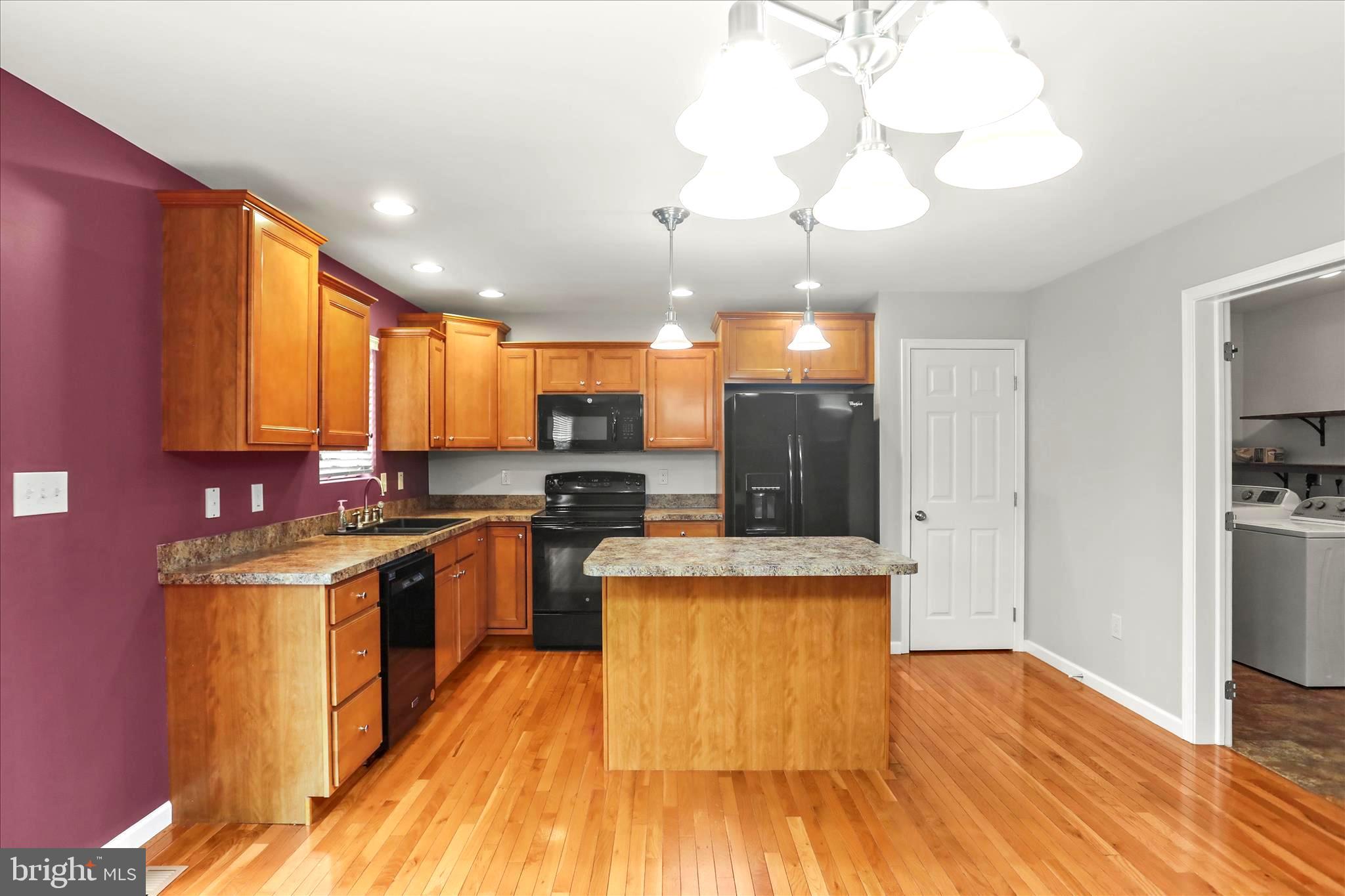 26 South 3rd Street New Freedom, PA 17349 - Photo 23 of 64 a kitchen with stainless steel appliances granite countertop wooden floors and sink