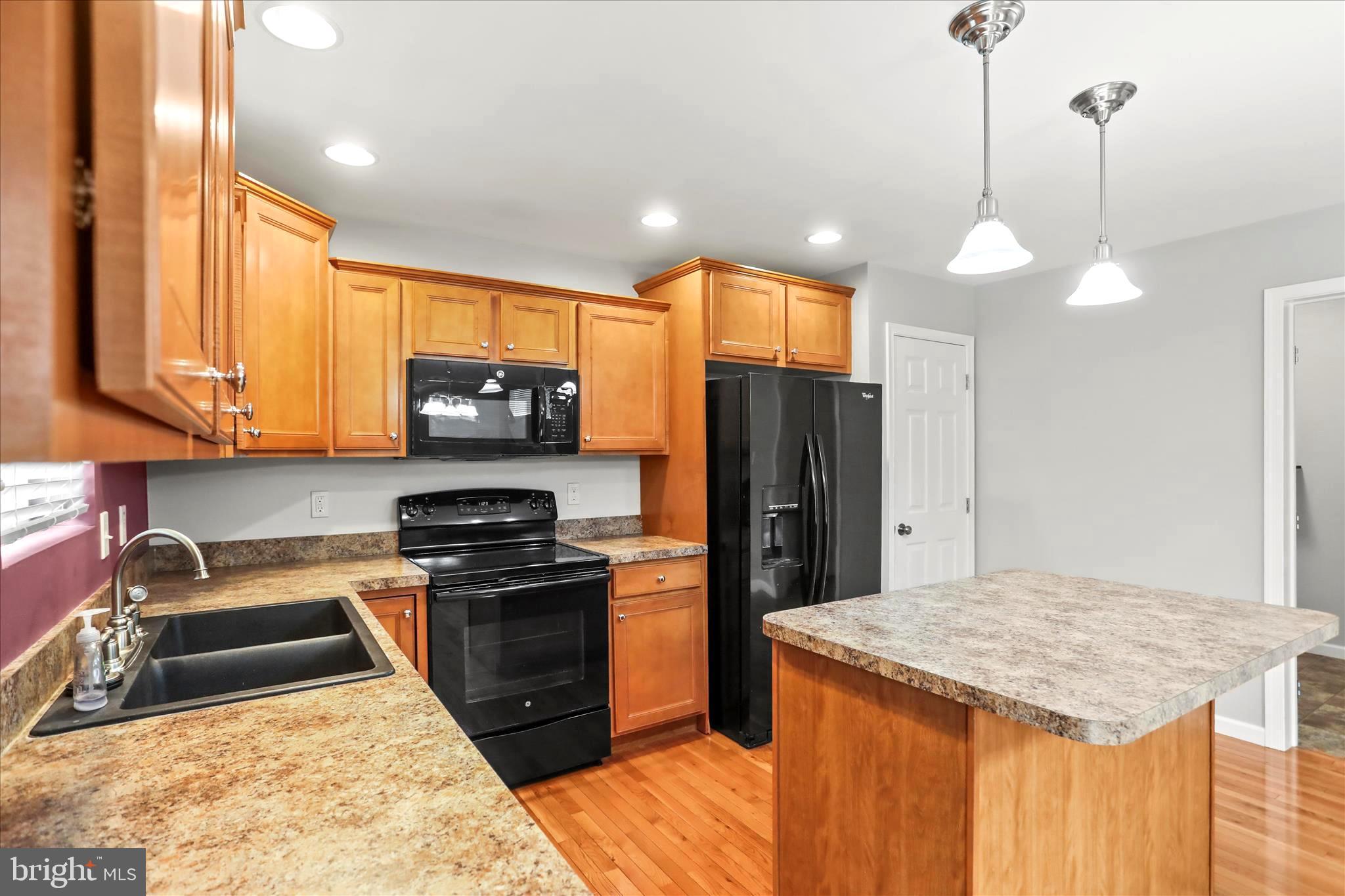 26 South 3rd Street New Freedom, PA 17349 - Photo 25 of 64 a kitchen with stainless steel appliances granite countertop a sink stove and refrigerator
