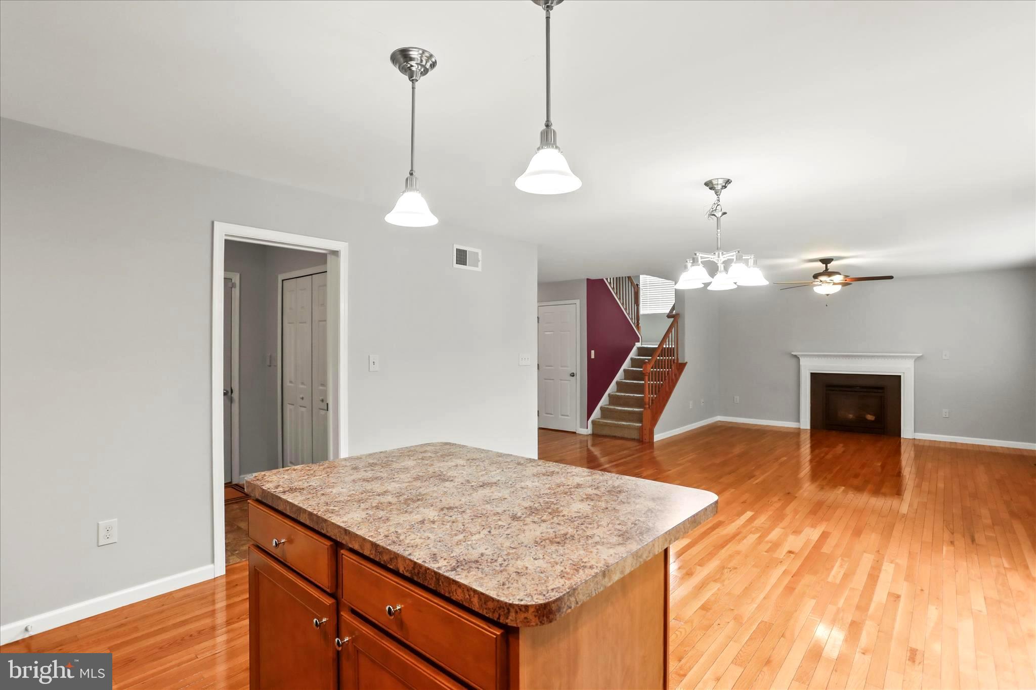 26 South 3rd Street New Freedom, PA 17349 - Photo 26 of 64 a kitchen with a sink a chandelier and wooden floor