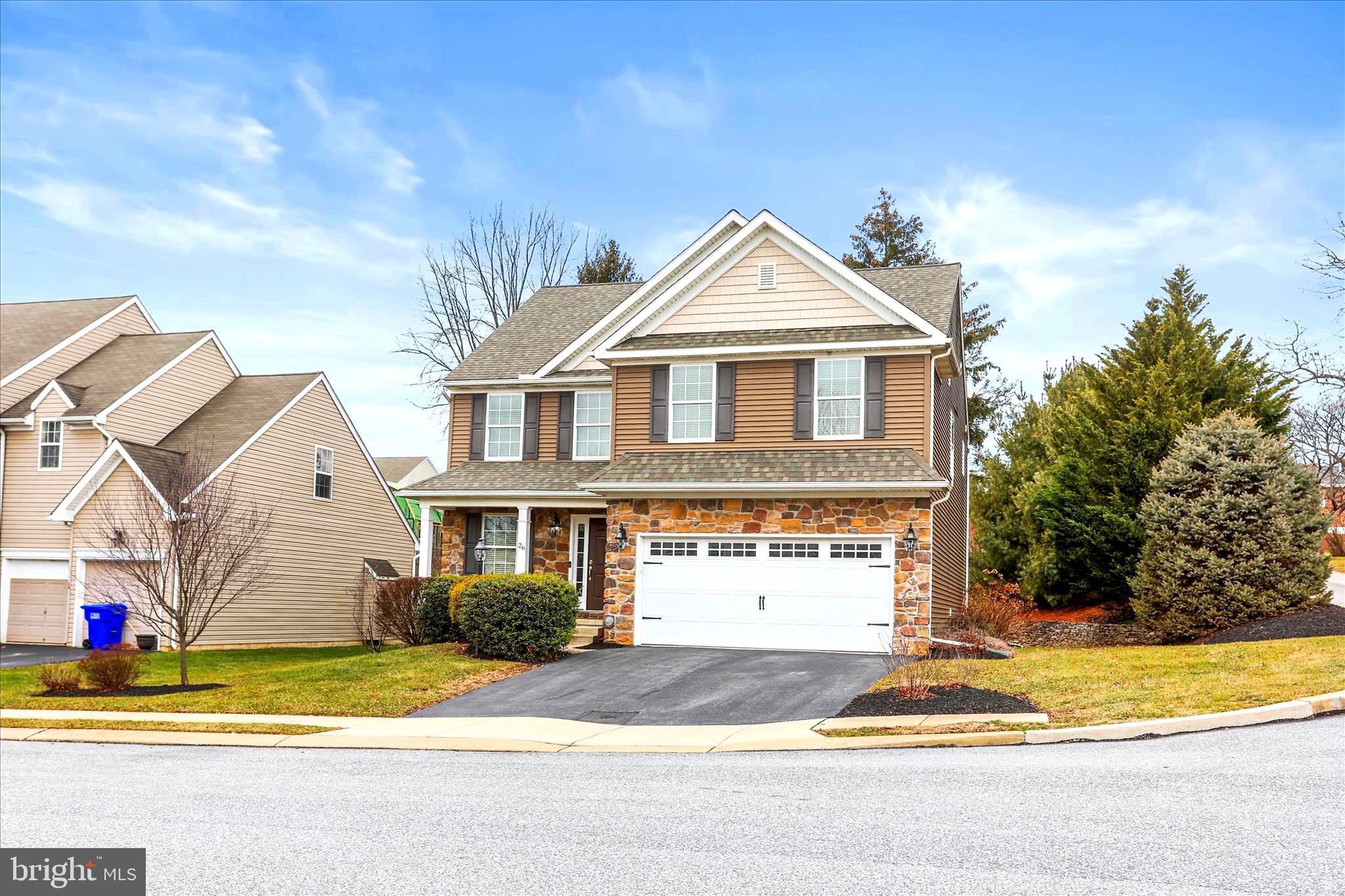 26 South 3rd Street New Freedom, PA 17349 - Photo 4 of 64 a view of a house with a yard and large tree and plants