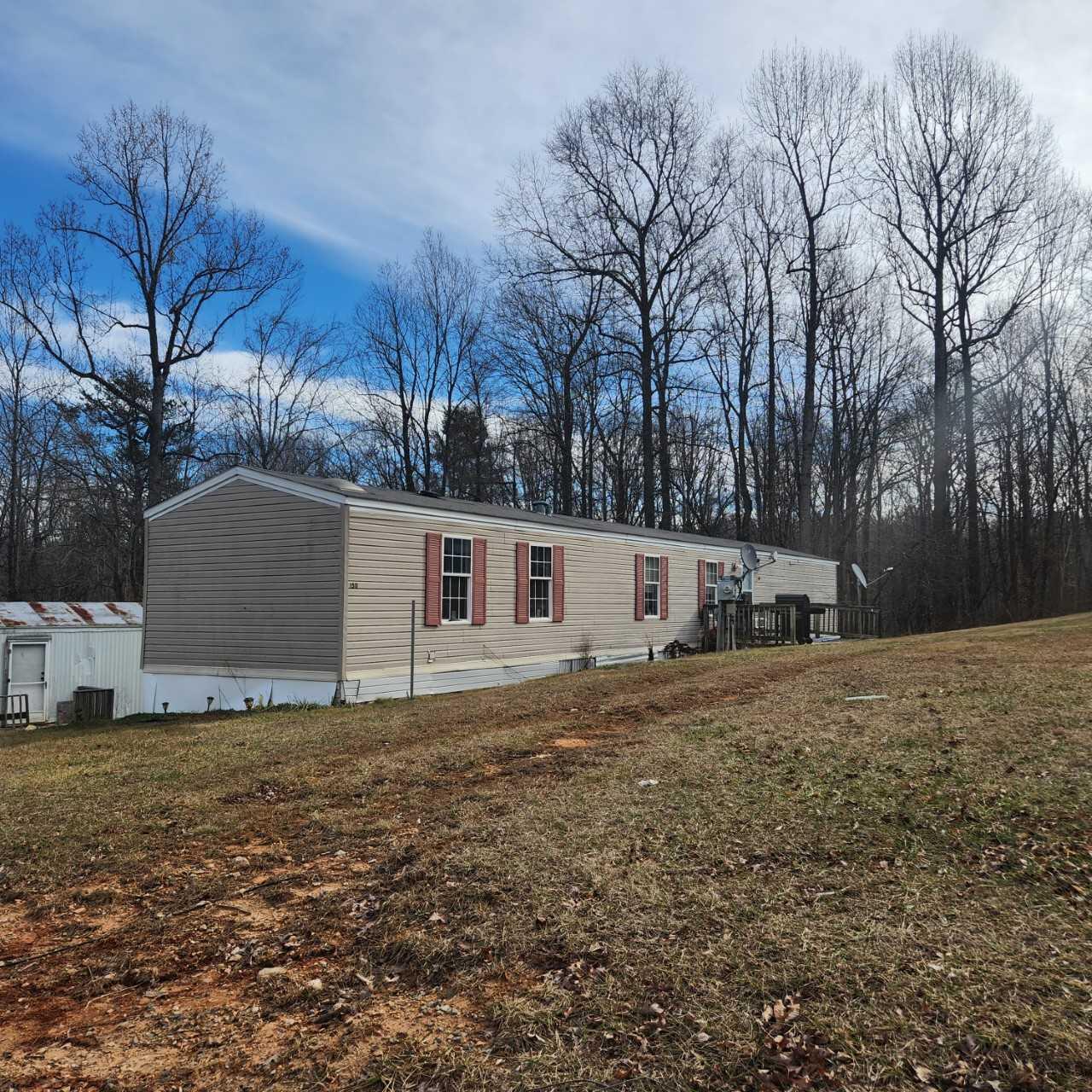 1735 Doe Run Road Rocky Mount, VA 24151 - Photo 3 of 6 a house that has a tree in front of it