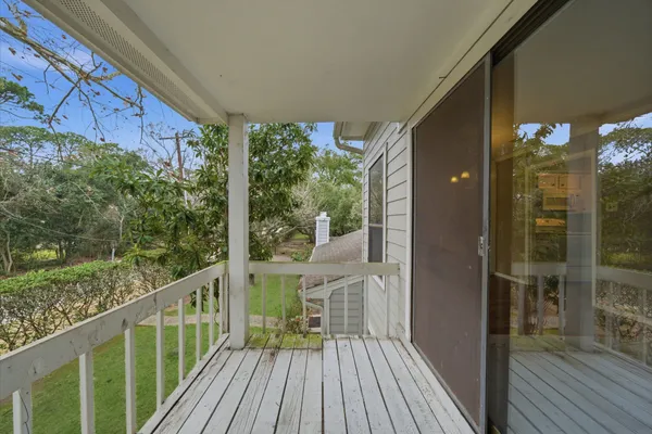 a view of a balcony with wooden floor