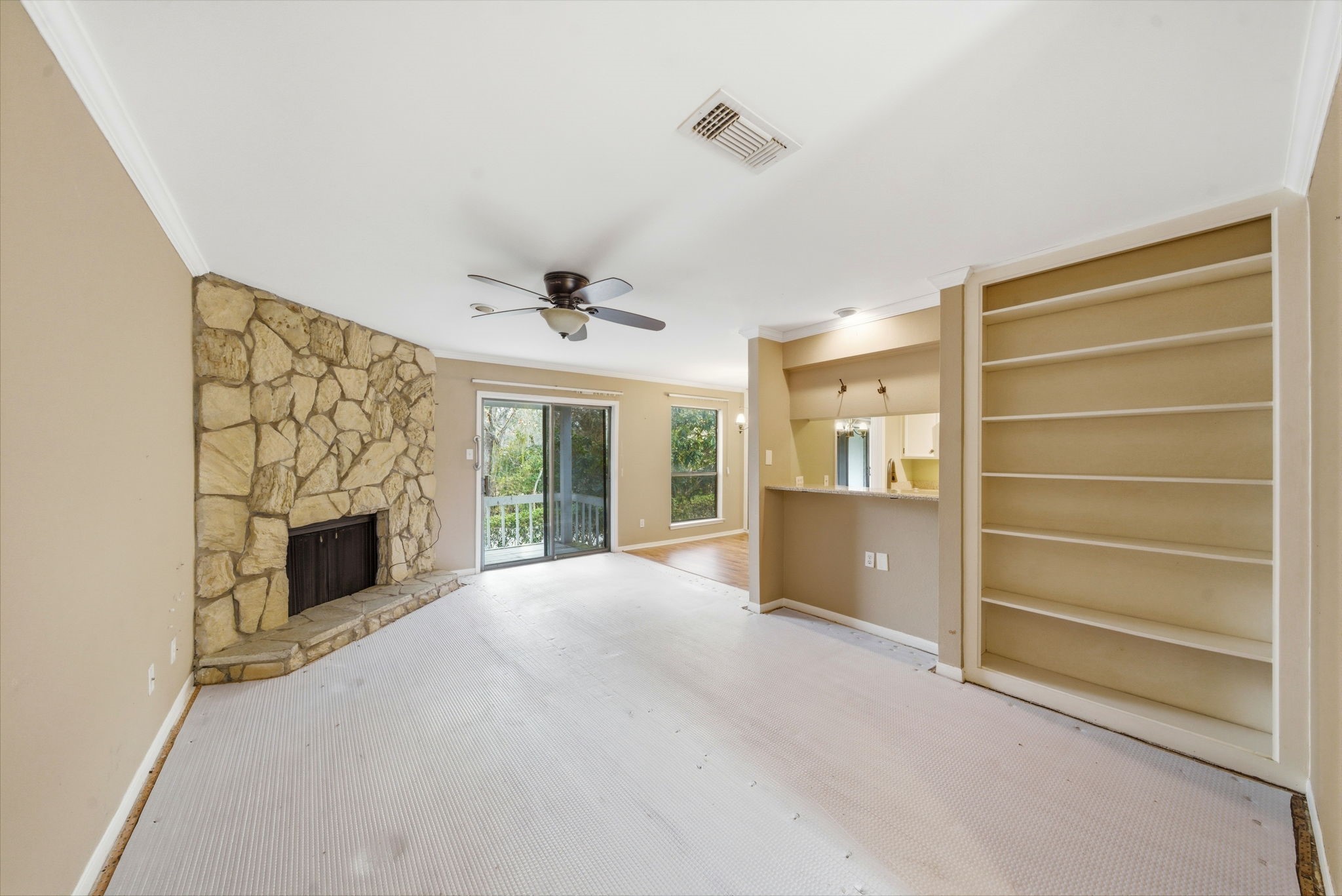 3 Hideaway Drive Friendswood, TX 77546 - Photo 4 of 12 a view of an empty room with a fireplace and a window