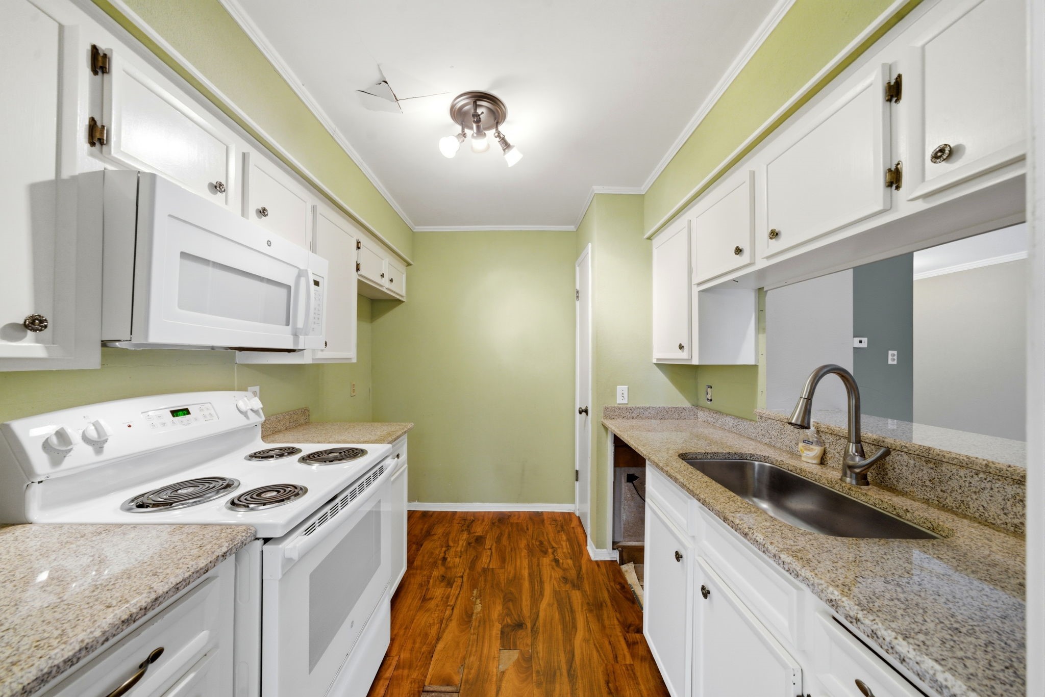 3 Hideaway Drive Friendswood, TX 77546 - Photo 10 of 12 a kitchen with a sink a stove and cabinets