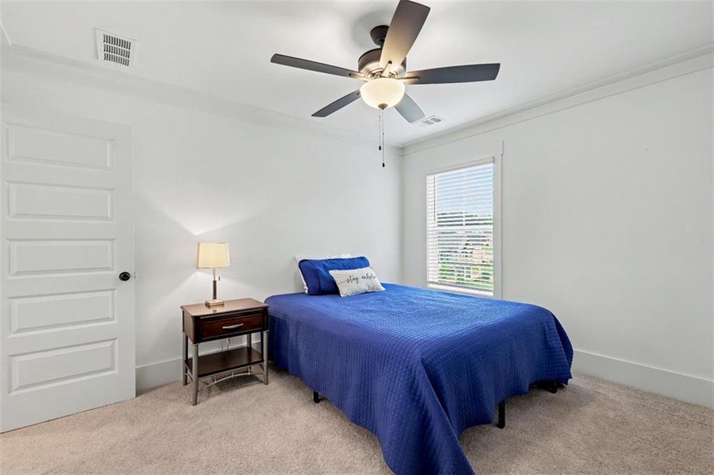 943 Clubside Drive Monroe, GA 30655 - Photo 53 of 93 a bedroom with a bed and a ceiling fan