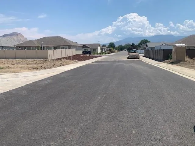 a view of a house with a yard and covered with snow in front of it