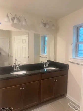 a bathroom with a granite countertop sink toilet and bathtub