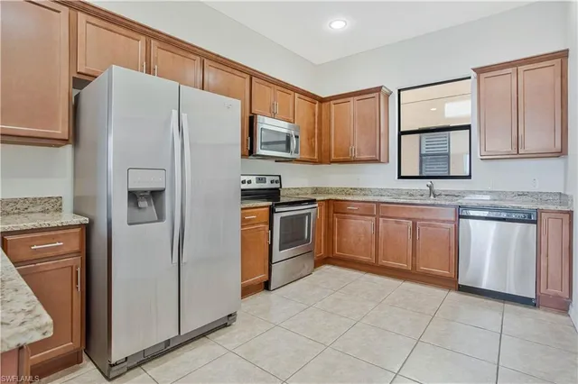 a kitchen with cabinets stainless steel appliances and a counter space