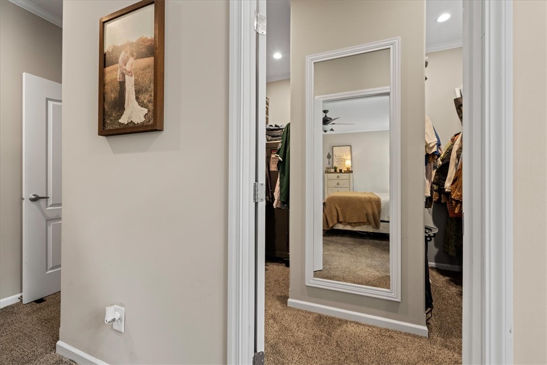116 Parkview Road Iva, SC 29655 - Photo 23 of 44 A clever floor-length mirror provides an intriguing reflection of the adjacent bedroom and a peak into a walk-in closet.