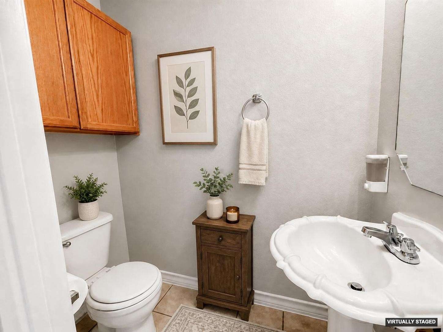 14828 Single Trace Austin, TX 78728 - Photo 8 of 30 White pedestal sink with chrome faucet, complemented by a wood-finish storage cabinet