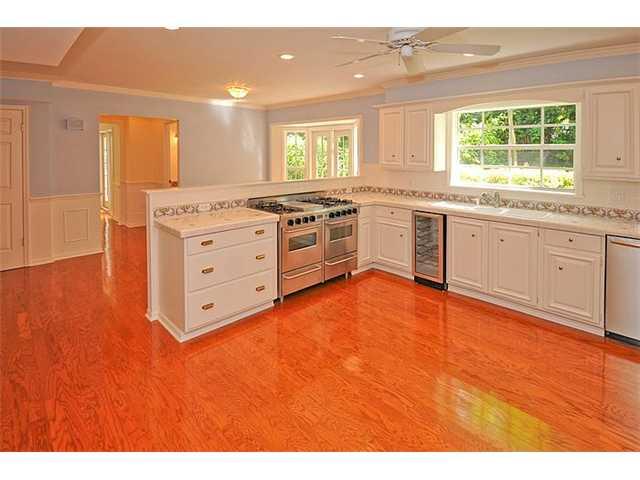 12 Ridgeview Road South Stuart, FL 34996 - Photo 3 of 22 a kitchen with stainless steel appliances granite countertop a stove a sink and a large window