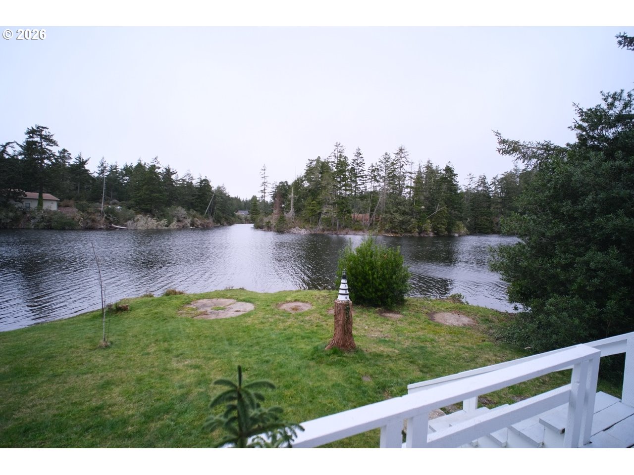 70214 Lakewood Road North Bend, OR 97459 - Photo 37 of 39 a view of a lake with houses in the back