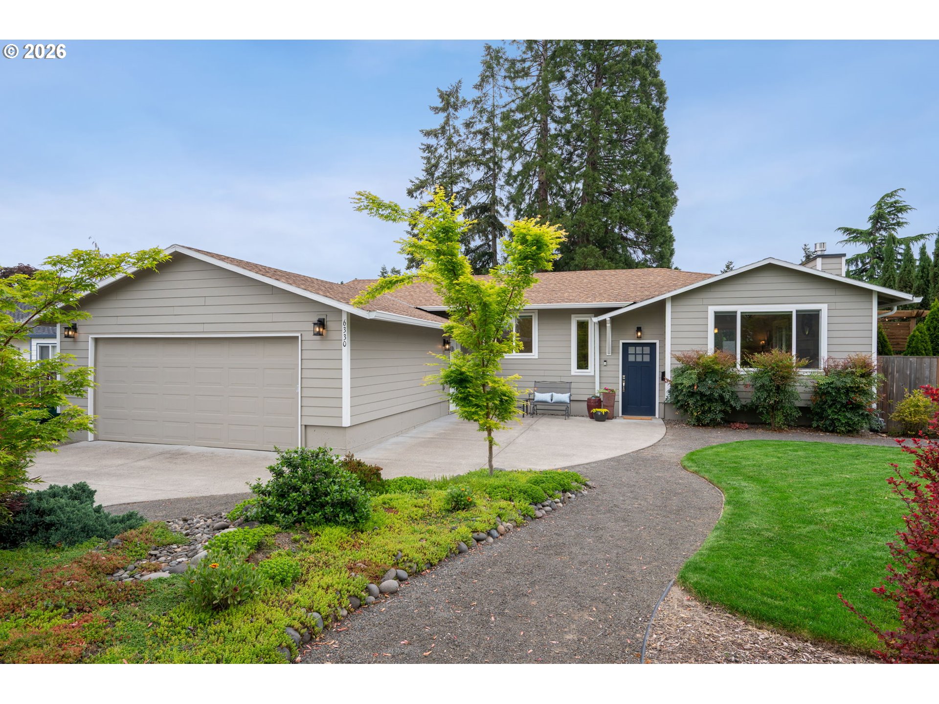 6330 Southwest Fisher Avenue Beaverton, OR 97008 - Photo 1 of 48 a front view of a house with garden