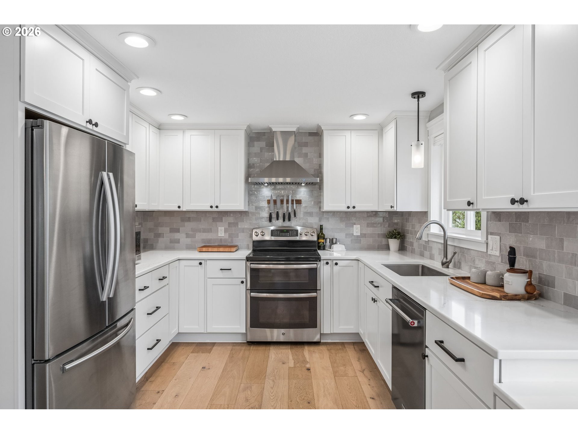 6330 Southwest Fisher Avenue Beaverton, OR 97008 - Photo 13 of 48 a kitchen with stainless steel appliances granite countertop a refrigerator sink and cabinets