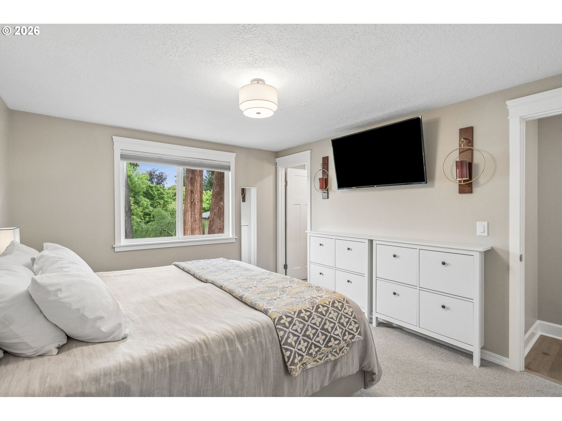 6330 Southwest Fisher Avenue Beaverton, OR 97008 - Photo 17 of 48 a bedroom with a bed a flat screen tv and a window