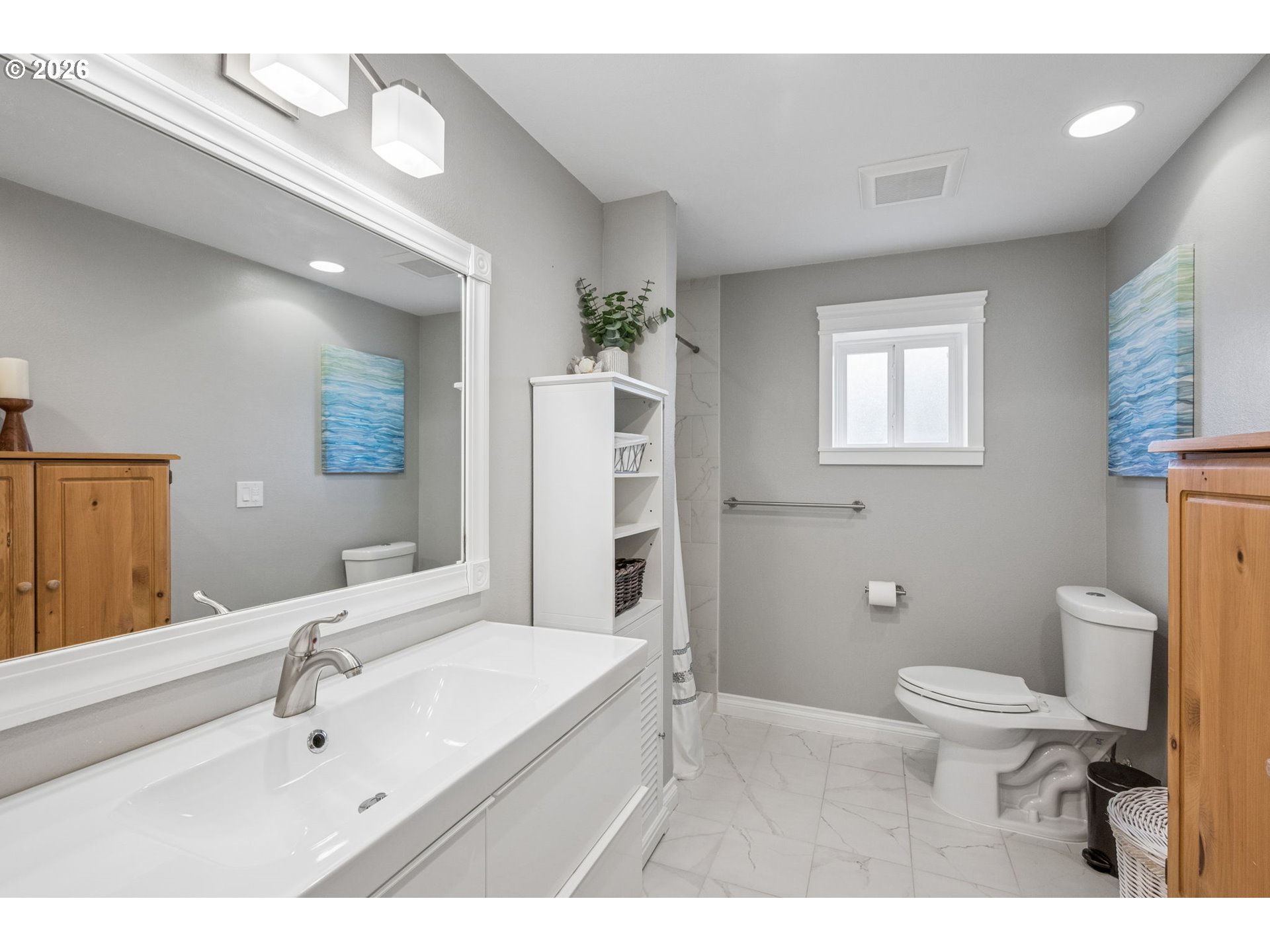 6330 Southwest Fisher Avenue Beaverton, OR 97008 - Photo 35 of 48 a bathroom with a sink a toilet a mirror and shower