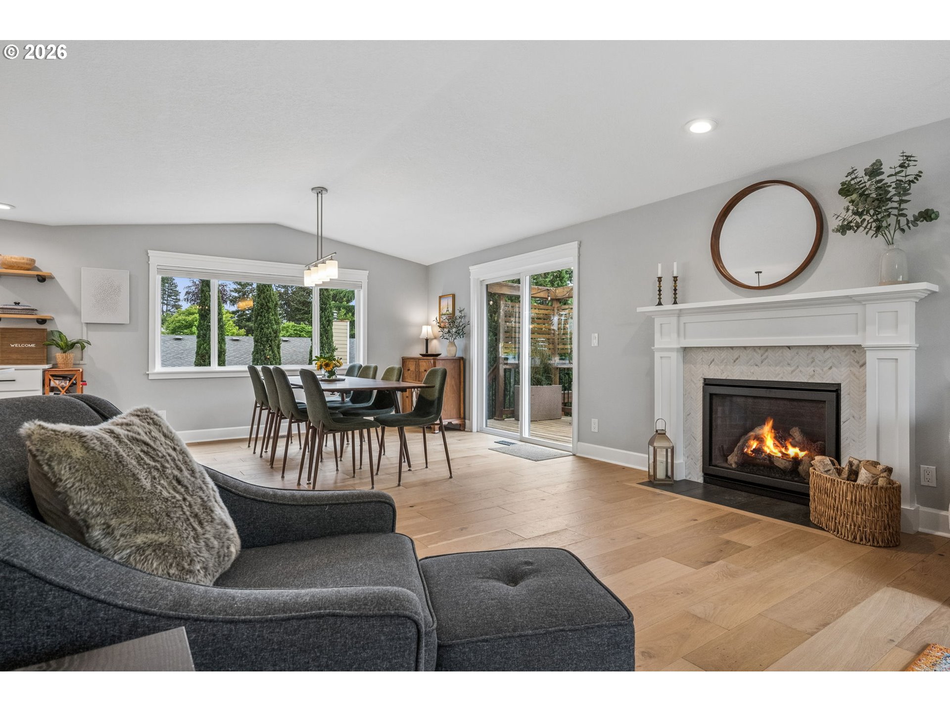 6330 Southwest Fisher Avenue Beaverton, OR 97008 - Photo 9 of 48 a living room with furniture a fireplace a clock and a large window