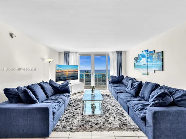 a bedroom with a bed and a large mirror