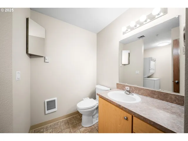 a bathroom with a sink a toilet and mirror