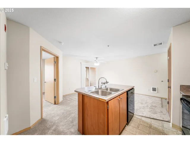 a kitchen with a sink and a refrigerator