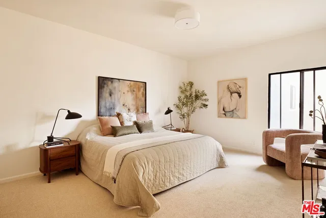 a bedroom with a bed and a couch