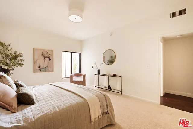 a bedroom with a bed window and wall painting