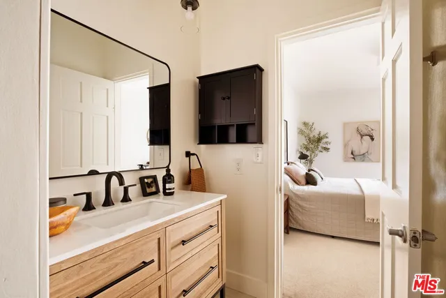 a bathroom with a double vanity sink mirror and