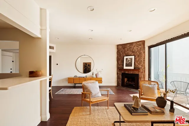 a living room with furniture a fireplace and a table