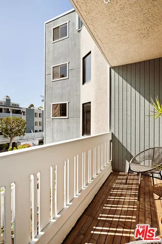 a balcony view with a black gate