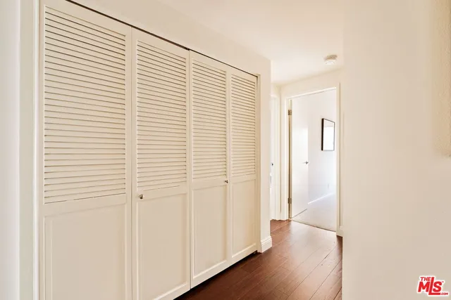 a view of a room with wooden floor