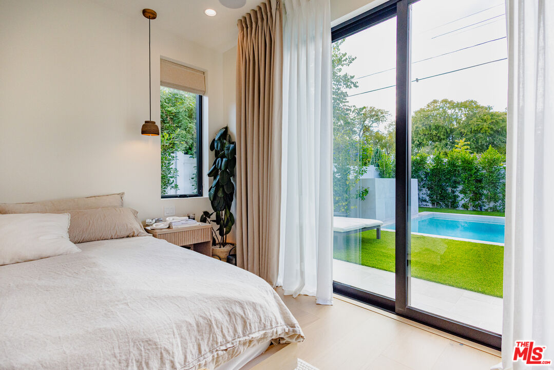 4703 Saloma Avenue Sherman Oaks, CA 91403 - Photo 15 of 26 a bedroom with a bed and a large window