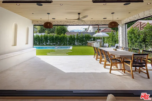 a dining space with furniture and garden view