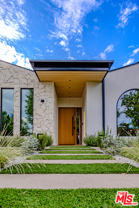 4703 Saloma Avenue Sherman Oaks, CA 91403 - Photo 4 of 26 a front view of a house with a yard